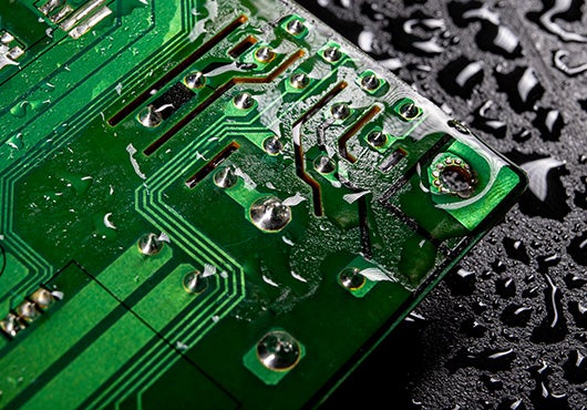 an electronic circuit board with water on it